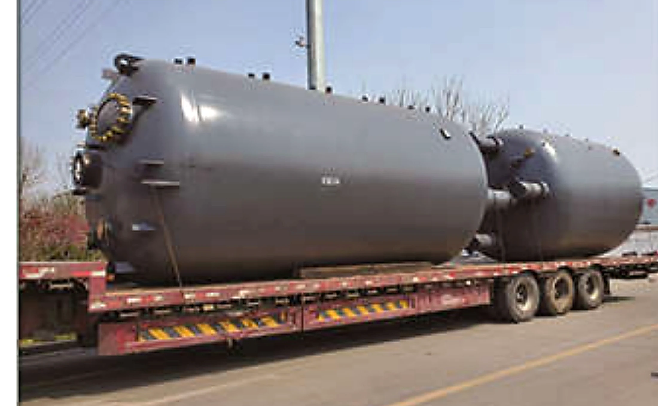 Glass-lined process vessel secured on a flatbed trailer for transport